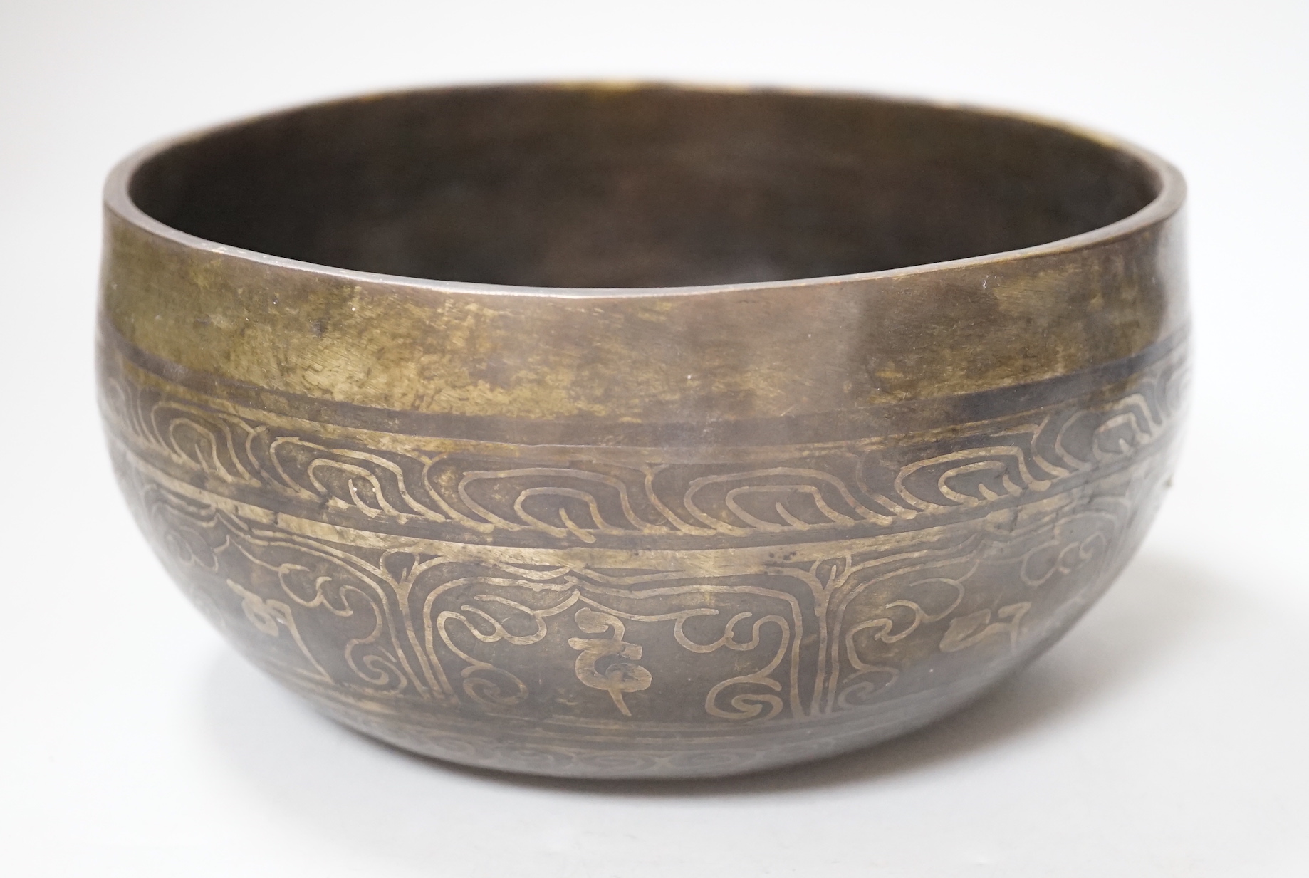 A Tibetan singing bowl with Sanskrit inscription, 19cm diameter